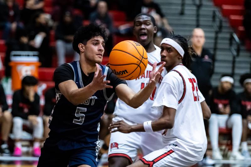 Oswego East's Zayn Manalodi gets control of the ball during a varsity boys basketball game against Bolingbrook at Bolingbrook on Dec. 12, 2025.