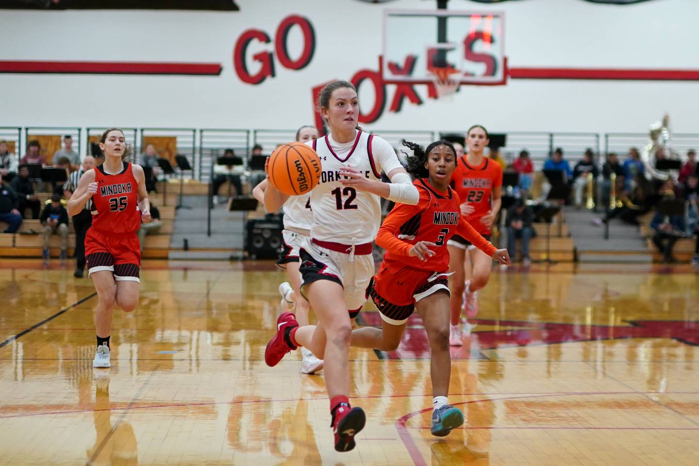 Yorkville's Elaine Gussman (12) drives to the basket off of a fast break against Minooka during a basketball game at Yorkville High School on Thursday, Dec. 5, 2024.