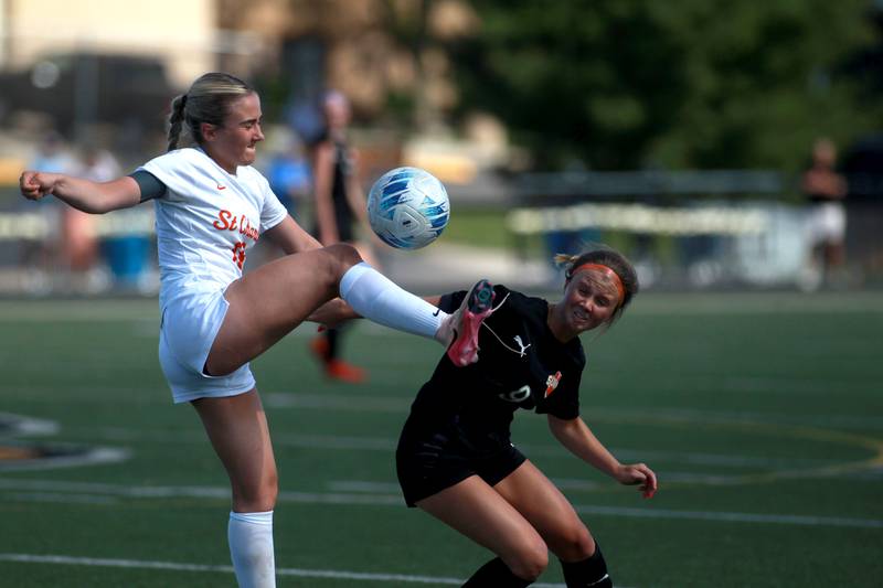 St. Charles East's Payton Rivard kicks the ball away from Wheaton Warrenville South's Kelsey Clousing during a game on Friday, May 16, 2025 in Wheaton.