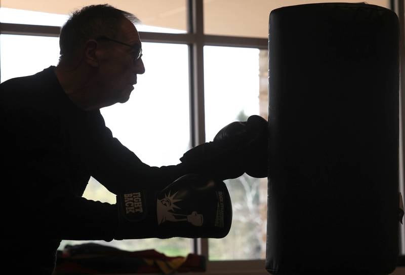 Peter Schram hits the bag Friday, April 28, 2023, during Rock Steady Boxing for Parkinson's Disease class at Northwestern Medicine Kishwaukee Health & Wellness Center in DeKalb. The class helps people with Parkinson’s Disease maintain their strength, agility and balance.