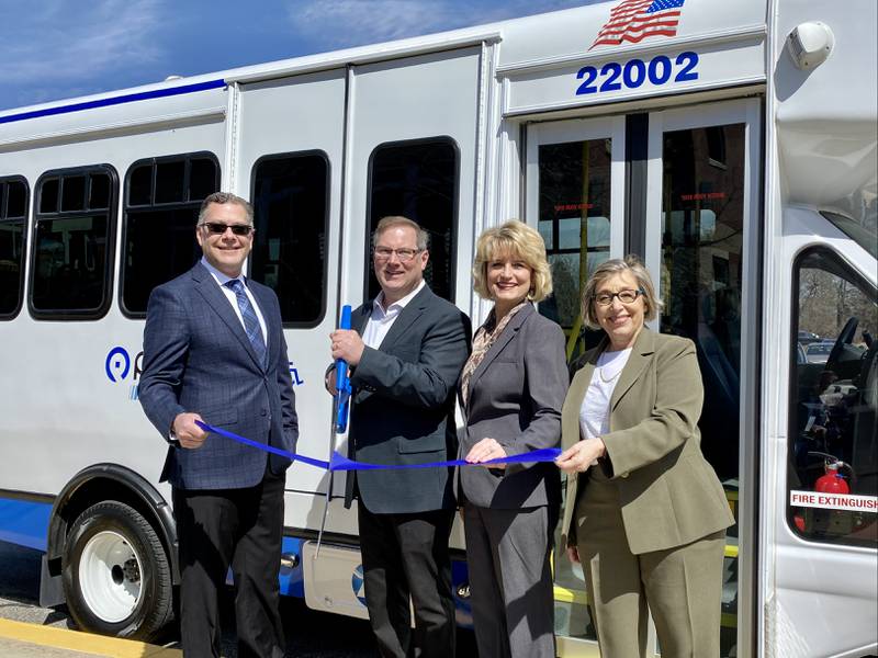 Officials celebrate the arrival of a new vehicle. From left to right: McHenry County Board Chairman Michael Buehler, Pace Chairman Rick Kwasneski, Pace Director Erin Smith, and Pace Executive Director Melinda Metzger.