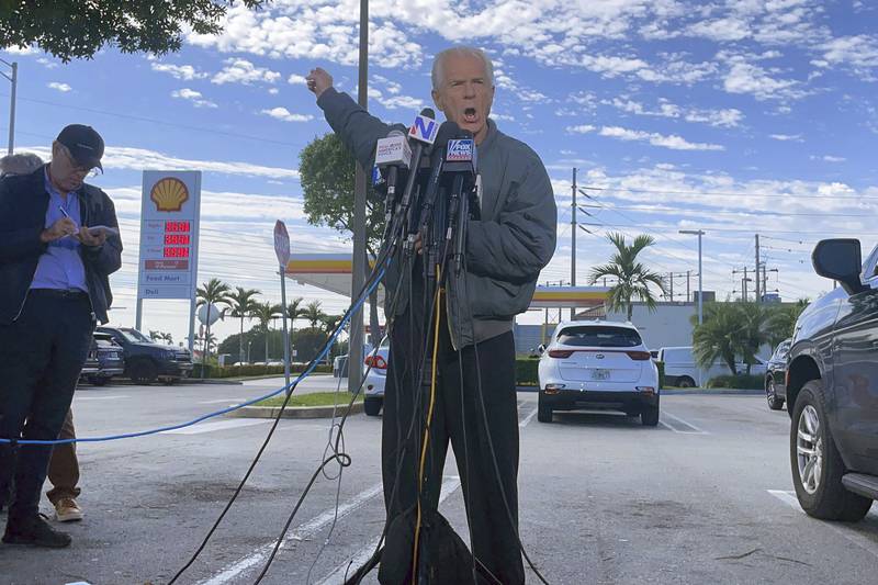 Former Trump White House official Peter Navarro speaks to reporters before he heads to prison, Tuesday, March 19, 2024 in Miami, to begin serving his sentence for refusing to cooperate with a congressional investigation into the Jan. 6, 2021, attack on the U.S. Capitol. (AP Photos/Adriana Gomez Licon)