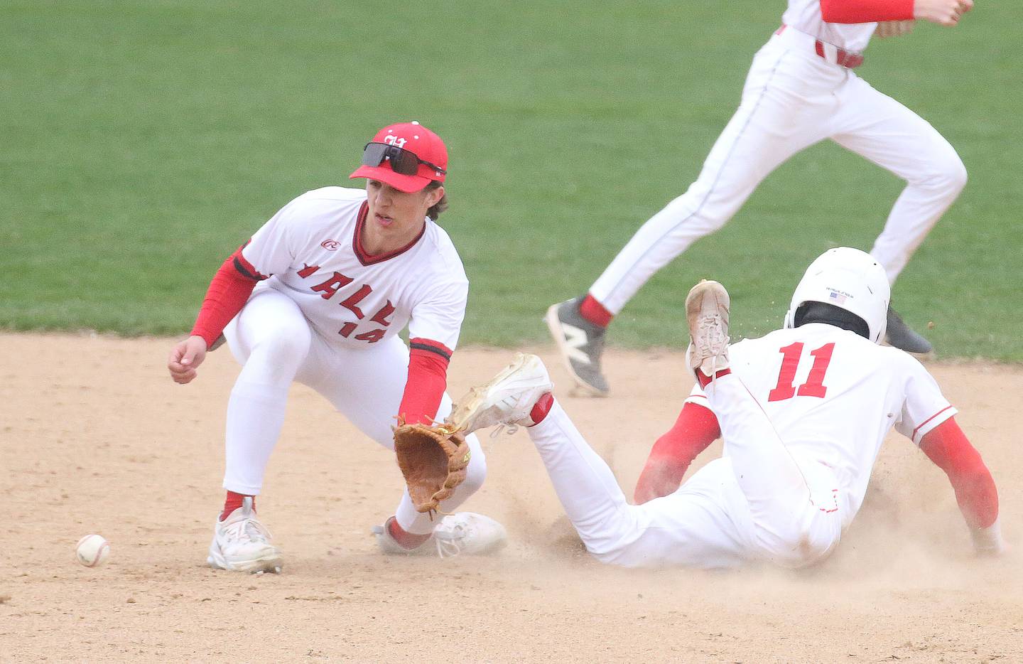 Hall's Geno Ferrari catches a late throw to second base as Ottawa's Adam Swanson steals the bag on Tuesday, April 1, 2025 at Ottawa High School.