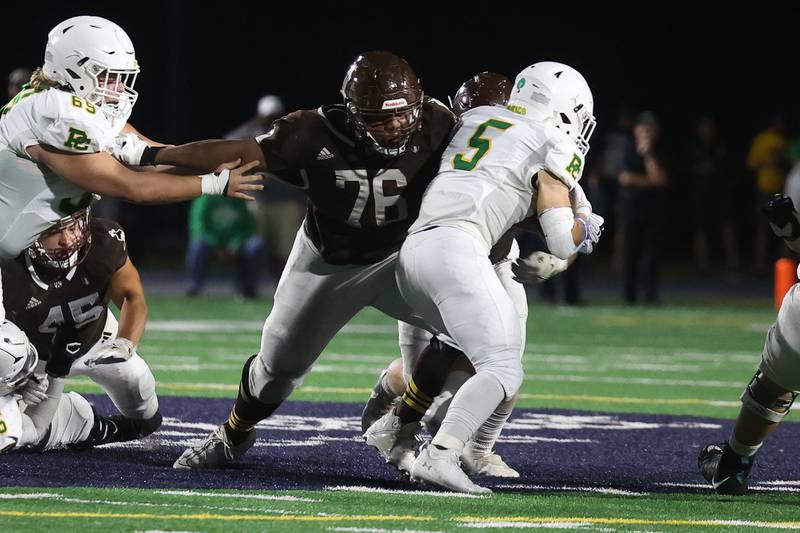 Joliet Catholic’s Dillan Johnson wraps up Providence’s Kaden Nickel for a loss on Friday, Sept. 1, 2023 Joliet Memorial Stadium.