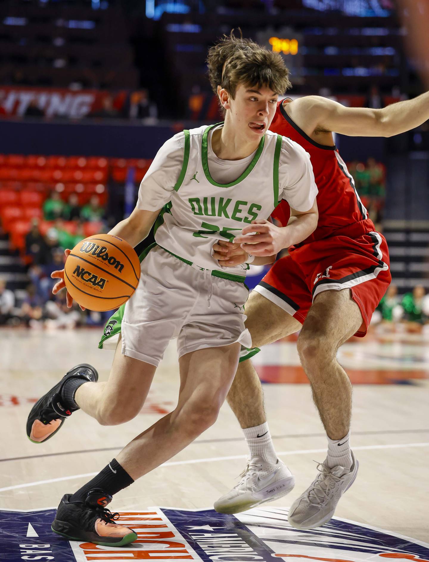 York’s Joseph Lubbe (25) slips to the basket past a Marist player during the IHSA Class 4A boys basketball state semifinal Friday, March 13, 2026 at the State Farm Center in Champaign.