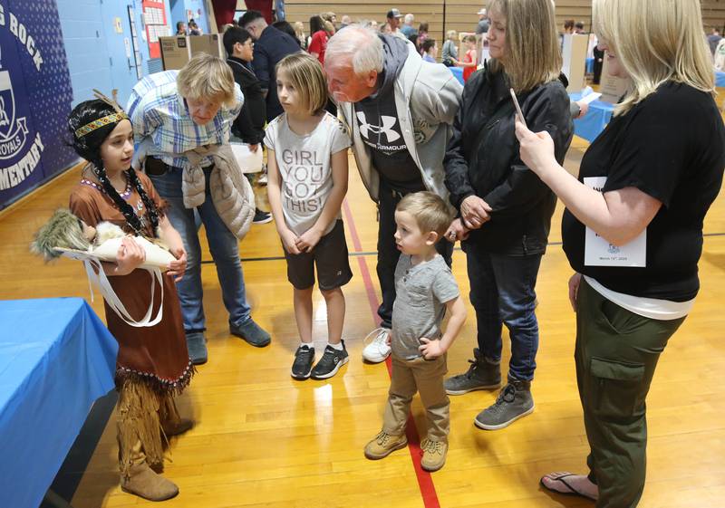Visitors lean in to hear third grader Maggie Diederich, who is portraying Sacagawea, give her speech during the Hinckley Big Rock Elementary School Wax Museum Thursday, March 13, 2025, at the school in Hinckley.