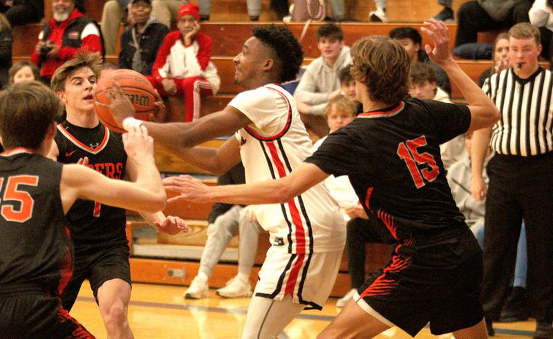 Huntley’s Bryce Walker navigates through heavy traffic against Crystal Lake Central during tournament basketball action at Johnsburg High School Monday evening.