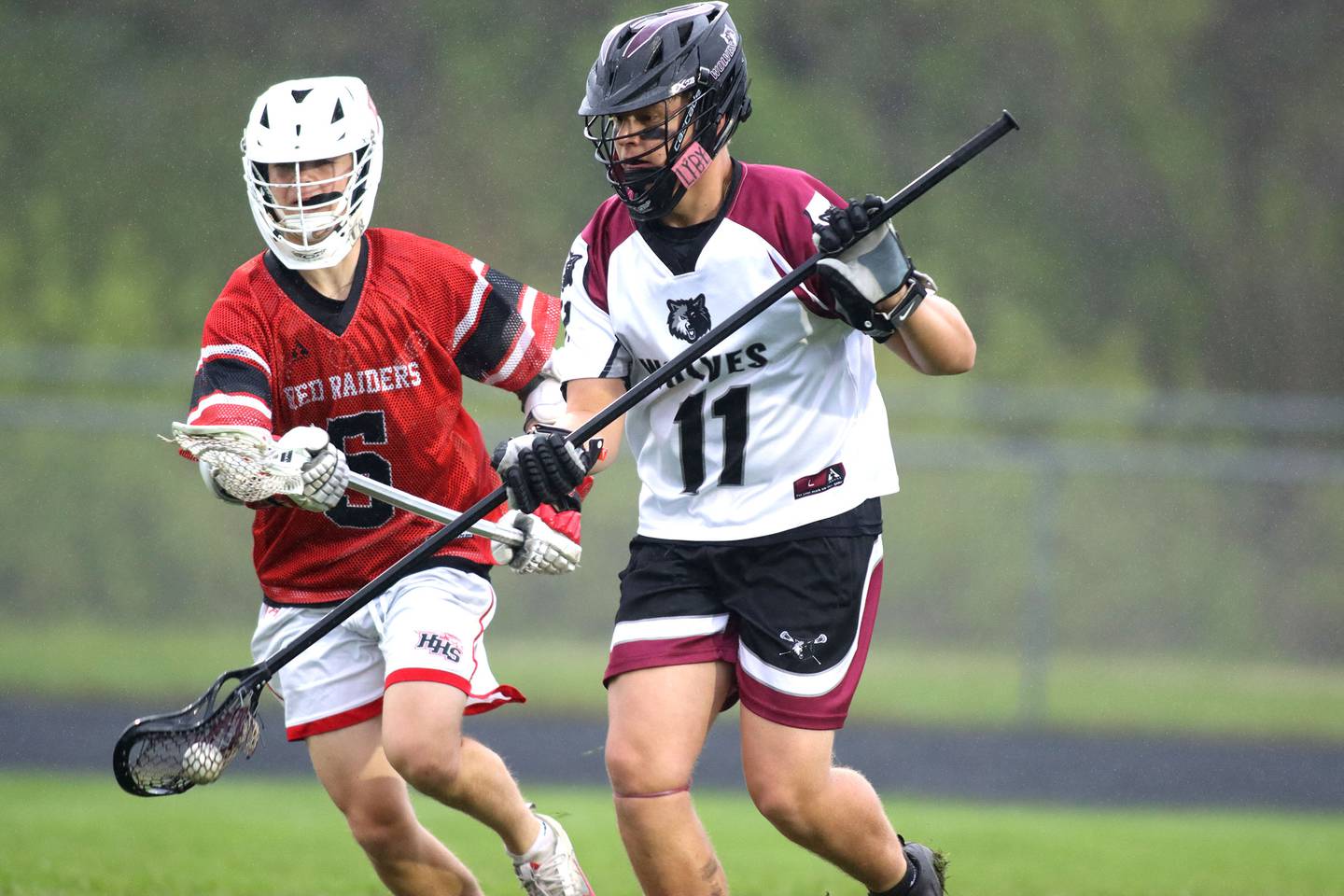 Huntley’s Nick Toman, left, pursues Prairie Ridge’s Trenton Horton in varsity boys lacrosse at Prairie Ridge  High School in Crystal Lake on Thursday, May 1, 2025.