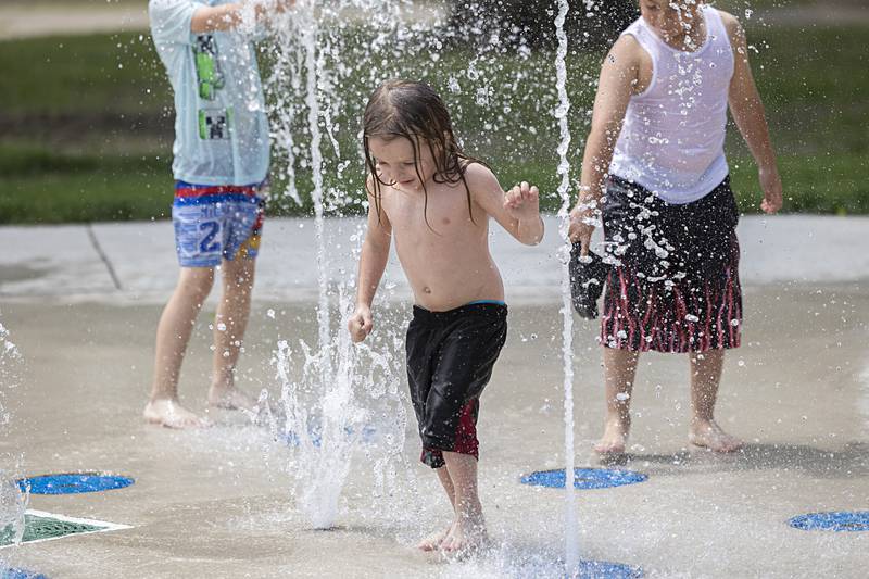 Greyson Ebersole, 7, reaches for the water at Sterling’s new Grandon Civic Center splash pad Wednesday, May 31, 2023.