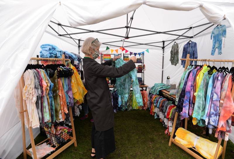 Susan Anderson-Nelson of Elmhurst takes a look at a sweatshirt during the Elmhurst Art Festival Saturday April 30, 2022.
