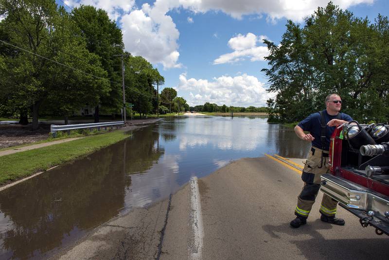 2019 FILE: Rock Falls firefighters block off a section of Dixon Avenue near Island View Drive as water flows over the route. Melvin Road and Nelson Road were also closed off due to the flooding.