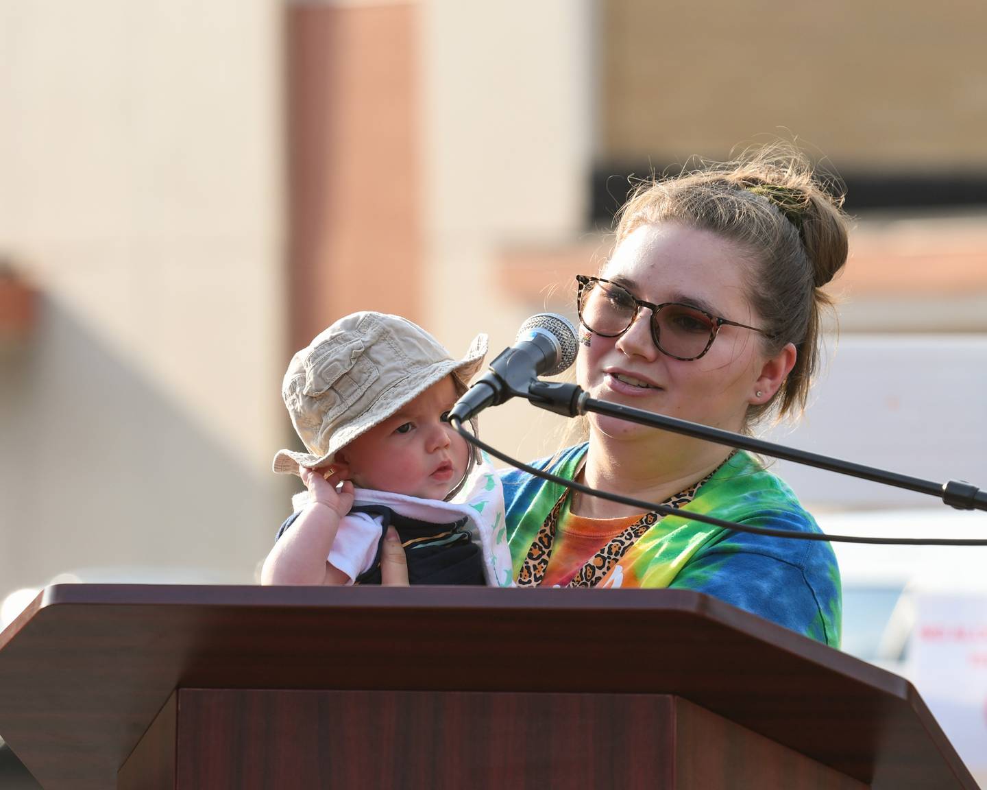 Beth Ganion and her 4-month-old son, James Ganion, speak during DeKalb Pride Fest held outside the Egyptian Theater, 135 N. Second St. in DeKalb on Thursday, June 22, 2023.