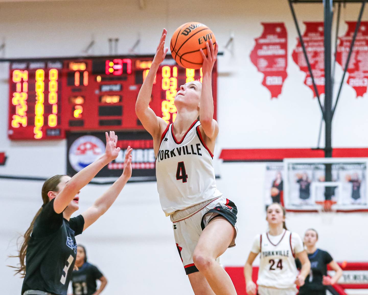 Yorkville's Macie Jones (4) goes up in a layup during their basketball game between Oswego East at Yorkville, Thursday  Dec 12, 2024 in Yorkville.