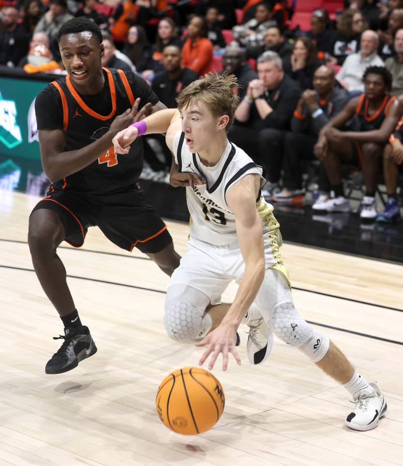 Sycamore's Xander Lewis goes baseline against DeKalb's Marquise Bolden during their game Friday, Jan. 31, 2025, in the FNBO Challenge in the Convocation Center at Northern Illinois University in DeKalb.