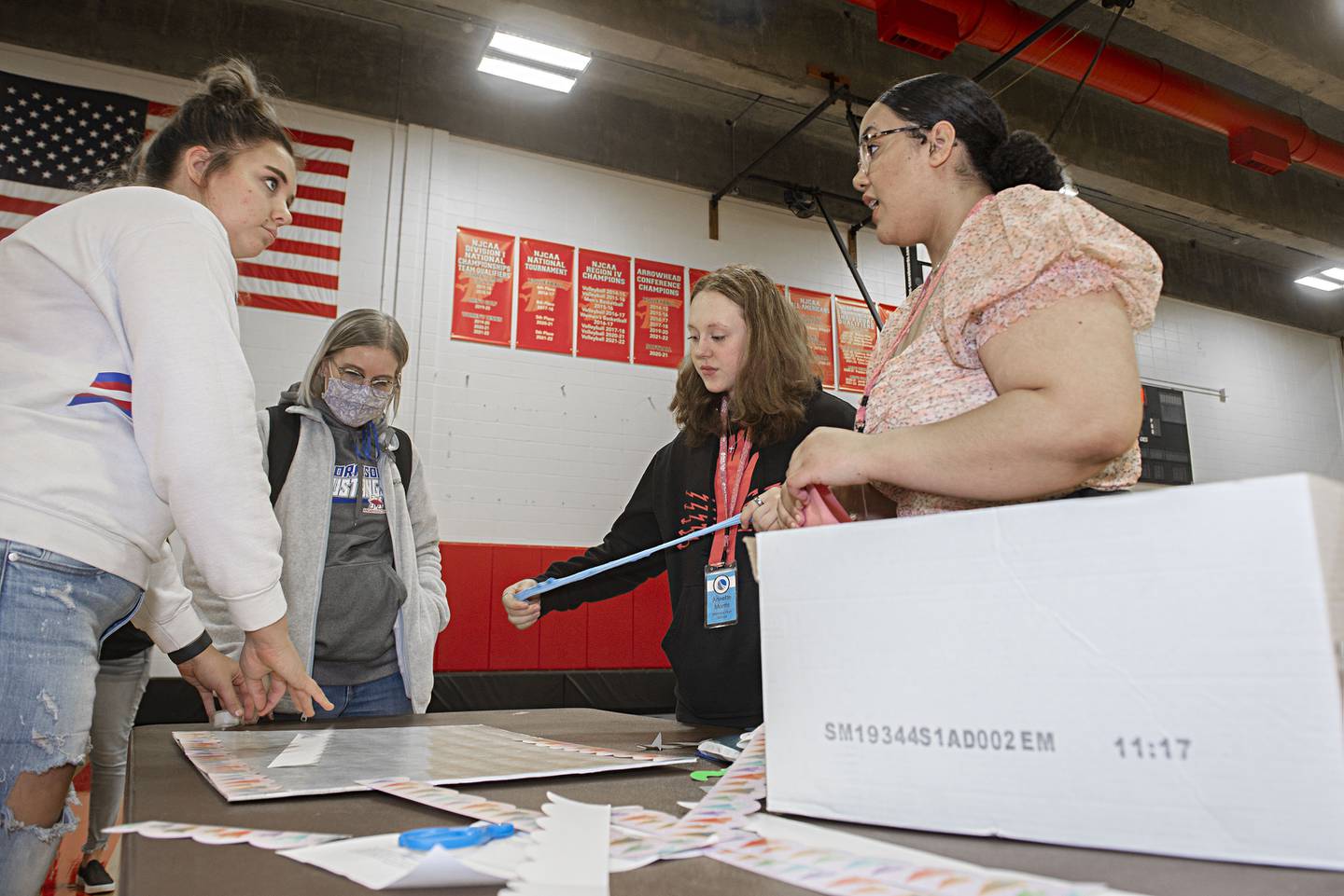 Morrison High School senior Faith VanderVinne (left), teacher Jennifer Stevenson, freshman Annett Morris and senior Tanna Frederick work on a task at SVCC’s Education Symposium on Friday.