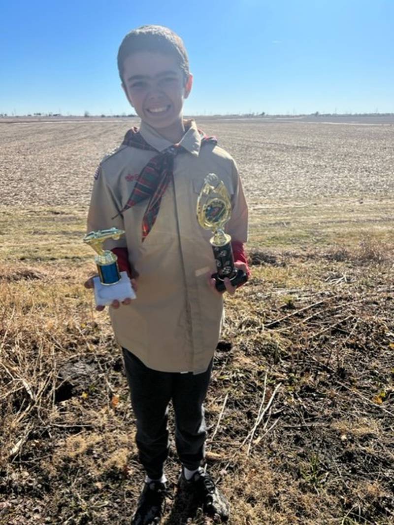 Ayden Arnold of Dixon Cub Scout Pack 85, stands with his trophies from the pinewood derby held Saturday, Feb. 11, 2023, at Bethel Evangelical Congregational Church in Dixon. Arnold, in recovery after a bone marrow transplant, watched a replay  of the race on video.
