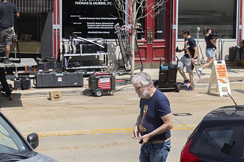 Mike Whye of Council Bluffs, Iowa snaps a picture of the filmmakers in downtown Dixon Monday, May 22, 2023. Whye had made a stop at a downtown bakery while on his way home from Chicago when he spotted the film crew.