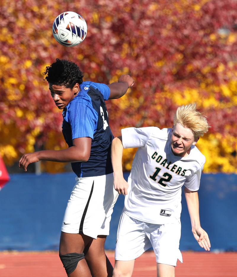 Coal City's Carter Hollis and Chicago Academy's Aaron Holloway go up for a header Friday, Nov. 7, 2025, during their Class 1A state third place game at Hoffman Estates High School.