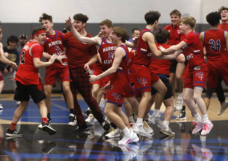 Marmion players and fans celebrate defeating Crystal Lake South in a IHSA Class 3A Sectional boys basketball game Tuesday, Feb. 28, 2023, at Central High School in Burlington.