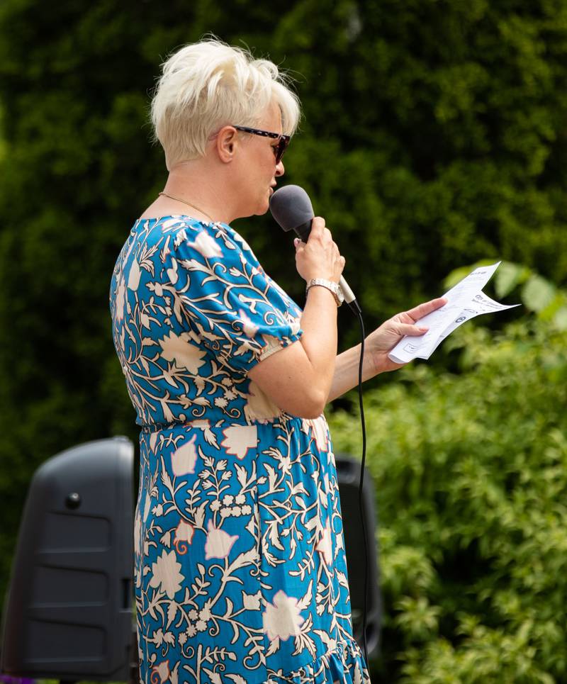 Elgin Heritage Foundation member Andrea Pokrefke sings a fight song during the Elmhurst Heritage Foundation's Vintage Baseball Game at Elmhurst University Mall on Sunday, June 4, 2023. Both teams from the city of Elmhurst and Elmhurst University played with baseball rules from 1850.
