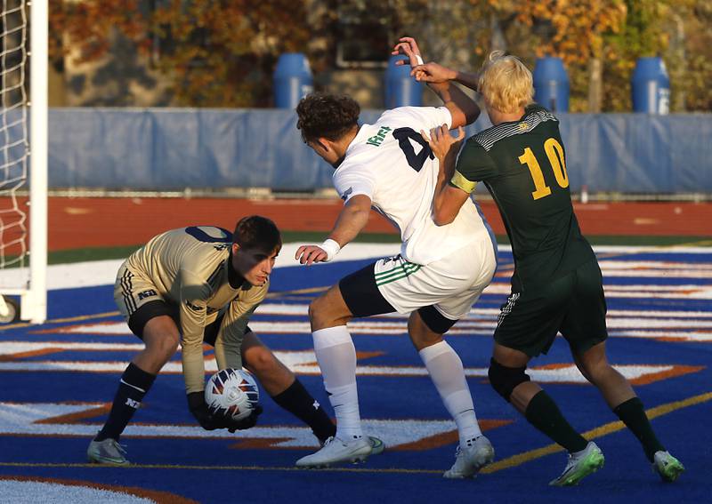 Peoria Notre Dame's Theodore Dimler grabs the ball as his teammate, Thomas Graham, blocks \cls10 from getting to the ball during the IHSA Class 2A state championship soccer match on Saturday, Nov. 4, 2023, at Hoffman Estates High School.