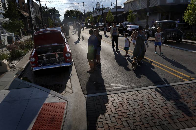 People check out muscle cars on Wednesday July 10, 2024, during the Cary Cruise Night. The weekly car show hosted by the Cary-Grove Area Chamber of Commerce draws about 125 cars and trucks each week. The event runs weekly on Wednesday through the end of August.