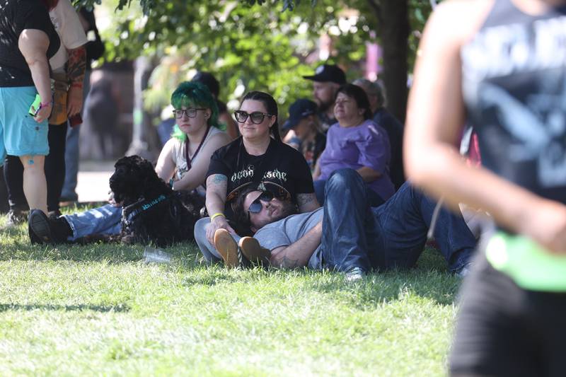 Amanda and Jason Melvin, who traveled from Pittsburg Ohio, relax in the shade as they enjoy the music on day one of Riot Fest, Friday, Sept. 15, in Chicago.