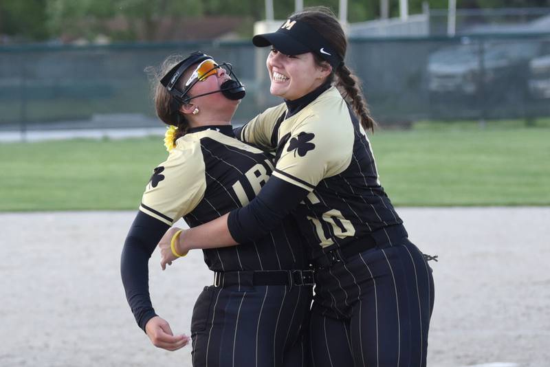 Bishop McNamara's Gabby Burnett, left, and Rhaya DePaolo embrace following the Fightin' Irish's 5-2 All-City win over Bradley-Bourbonnais at home Thursday, May 7, 2026.