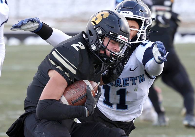 Sycamore's Elijah Meier carries the ball after intercepting a Nazareth pass attempt Saturday, Nov. 18, 2022, during their state semifinal game at Sycamore High School.