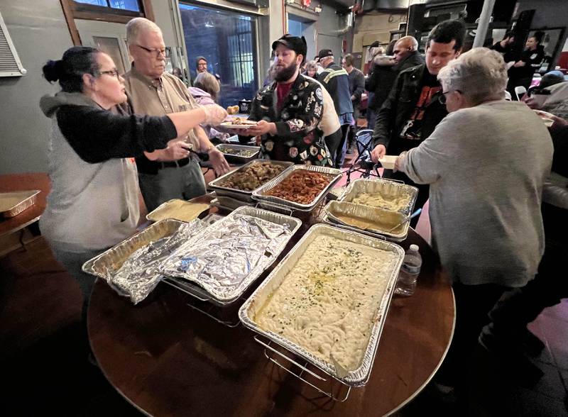 Volunteers fill up plates for visitors Wednesday, Nov. 26, 2025, during A World of Thanks, Community Thanksgiving hosted by DeKalb Mutual Aid at the McCabe’s building in DeKalb.