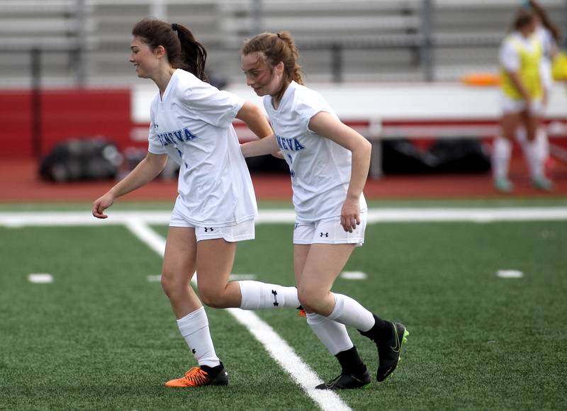 Geneva’s Olivia Rawls (left) and Alana Rawls celebrate Olivia’s goal in the second half of a Naperville Invitational game against Oswego at Naperville Central on Saturday, April 23, 2022.