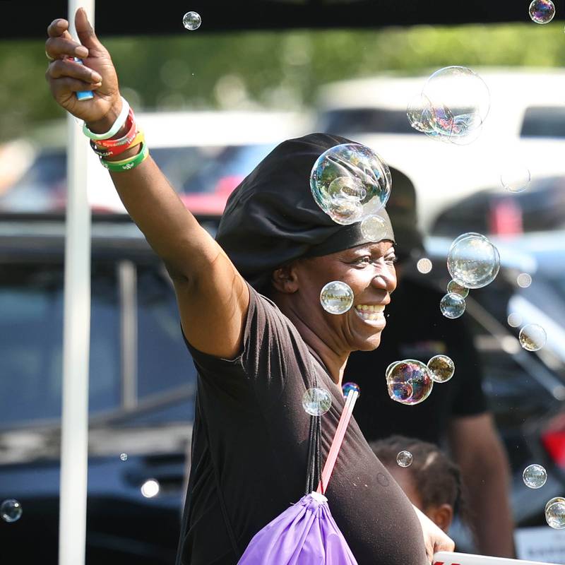Dianatha Hardesty, from DeKalb, has some fun in the bubbles at the DeKalb County Convention and Visitors Bureau booth during the Family Fun Fest Wednesday, July 17, 2024, at Hopkins Park in DeKalb.
