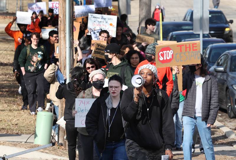 Northern Illinois University students march up Carroll Avenue Friday, Feb 13, 2026, on their way to the DeKalb Police Department on Lincoln Highway to protest against recent U.S. Immigration and Customs Enforcement activity.