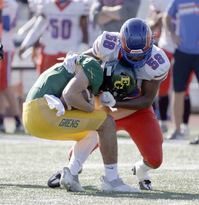 Elk Grove’s Mitchell Janczak, 12, is brought down by Hoffman Estates’ Damarion Anderson, 58, Saturday October 29, 2022 in Elk Grove Village.