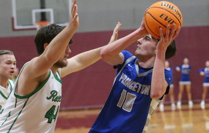 Princeton's Gavin Lanham eyes the hoop over Rock Falls's Garret Wolf during the Class 2A Sectional final on Friday, March 7, 2025 at Marengo High School.