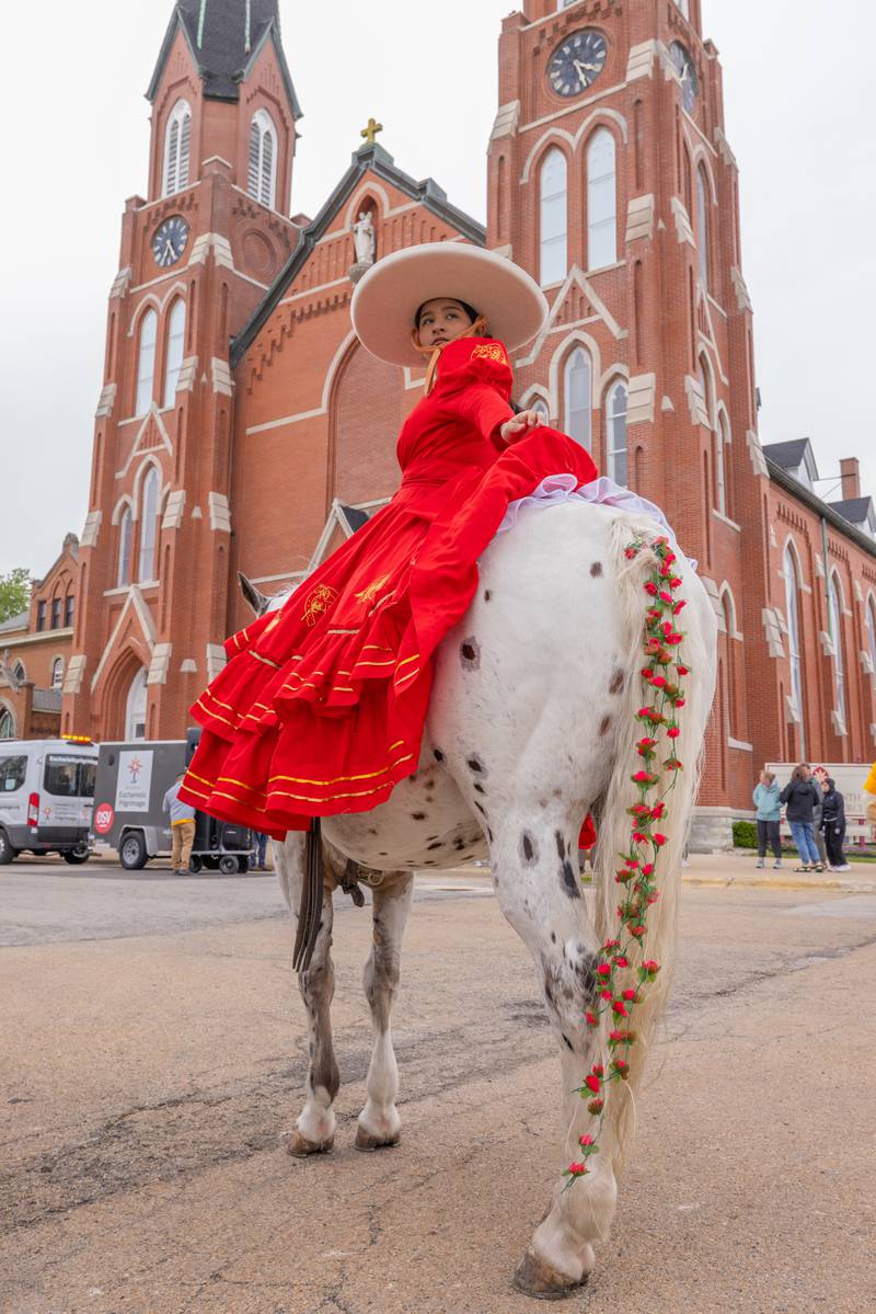 Xosely Mondragon looks back at her mother from atop of her horse prior to the start of the crosstown procession for the National Eucharistic Pilgrimage on Monday, May 19, 2025, in La Salle. The pilgrimage made three stops in the La Salle area and began in the Archdiocese of Indianapolis.