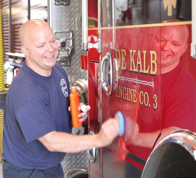 DeKalb firefighter Andrew Romano waxes the departments newest engine Tuesday, May 16, 2023, in the apparatus bay at Fire Station 3 in DeKalb.