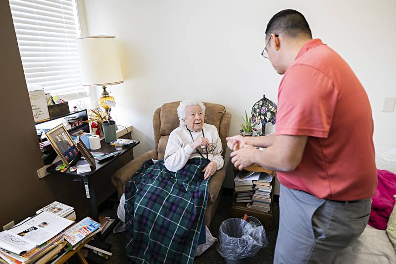 Liberty Court resident Ruth Craig tells Li Arellano of how she worked worked during WWII Thursday, Nov. 16, 2023 during his visit to the care facility.