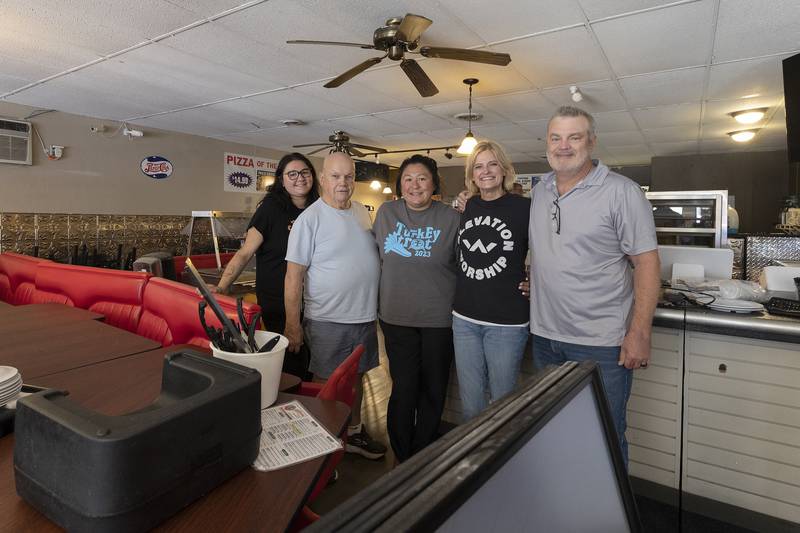 Previous owners Larissa McClain (left), Jim Gallentine and Melissa Gallentine have sold Mama Cimino’s to Heather and Greg Huffman.