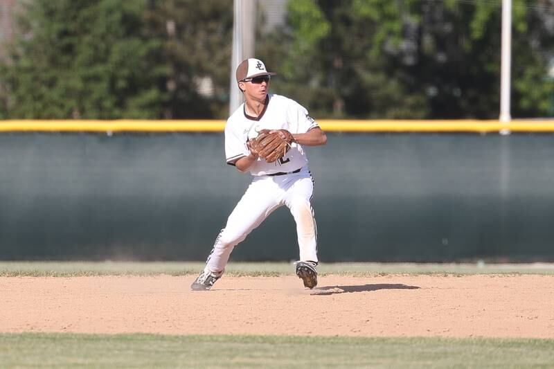 Joliet Catholic’s Tommy Kemp throws to first for the the out against Leo in the Class 2A sectional semifinal on Thursday, May 25, 2023, in Joliet.