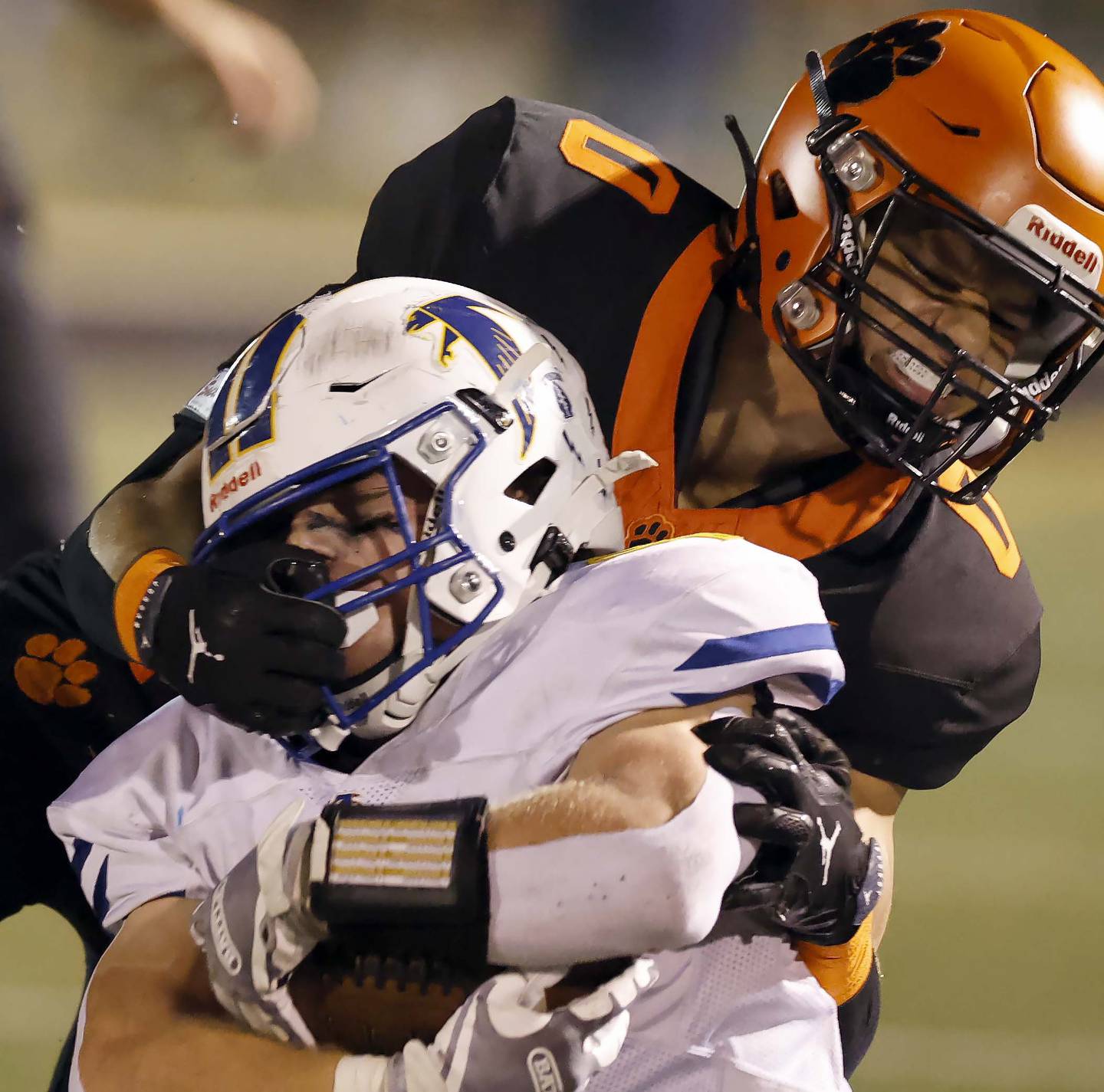 Wheaton Warrenville South's Amare Williams (0) wraps up Wheaton North's Max Serbick (4) Friday, Oct. 3, 2025 at Red Grange Field in Wheaton.