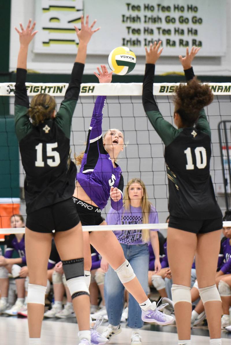 Manteno's Kendall Blanchette, center, looks to send a hit between Bishop McNamara's Jersey Slone, left, and Trinitee Thompson during a game at Bishop McNamara Monday, Oct. 20, 2025.