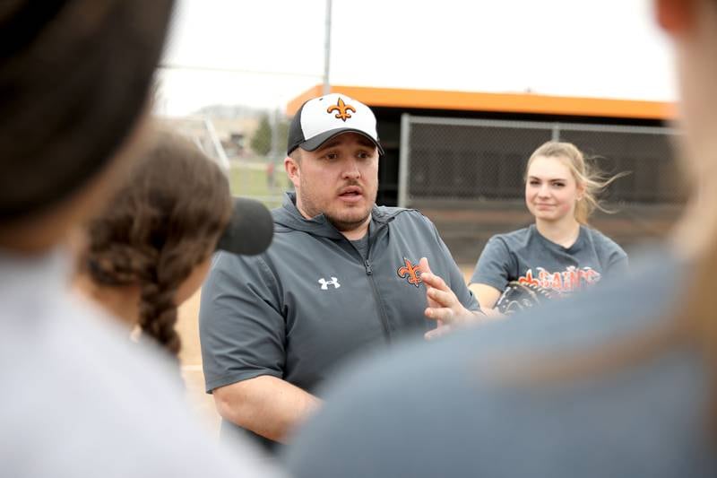 Assistant Coach Max Payleitner, a graduate of St. Charles schools, works with the St. Charles East varsity softball team during a recent practice at the school. Payleitner is also a teacher in St. Charles School District 303.