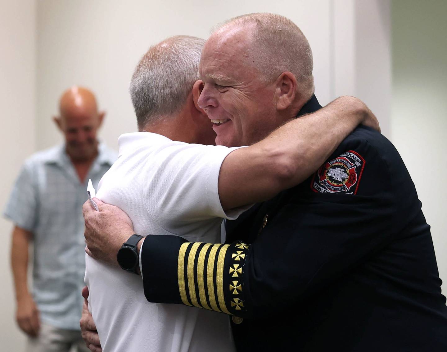 Retiring DeKalb Fire Chief Mike Thomas gets a hug from mayor Cohen Barnes Monday, June 23, 2025, as he is thanked for his 30 years of service during the DeKalb City Council meeting at the DeKalb Public Library.