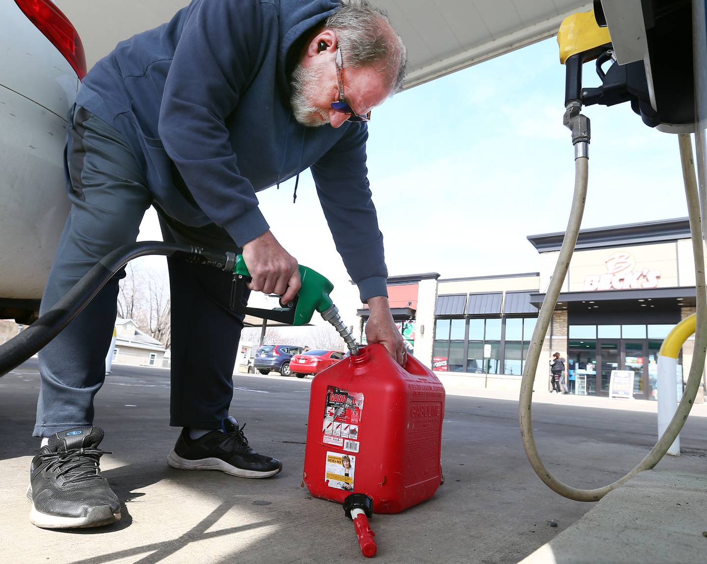 John Woelfel of Niles, Mich., fills up his 5-gallon gas tank on Thursday, March 17, 2022. Oil prices are currently below $100 a barrel, but the average price of a gallon of gasoline is still $4.32 a gallon.