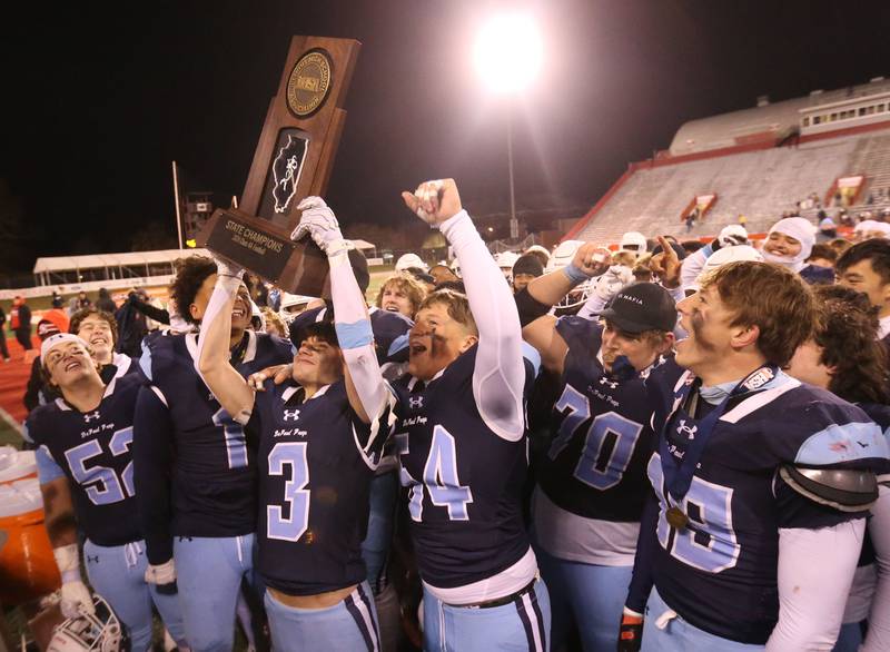Members of the DePaul football team hoist the Class 4A State football championship trophy on Friday, Nov. 29, 2024 at Hancock Stadium in Normal.