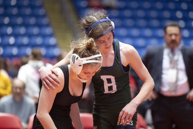 Emma Engels of Bartlett (right) hugs opponent Alexandra Sebek in the 100 pound championship match at the IHSA girls state wrestling championships Saturday, Feb. 25, 2023. Engels took the win.