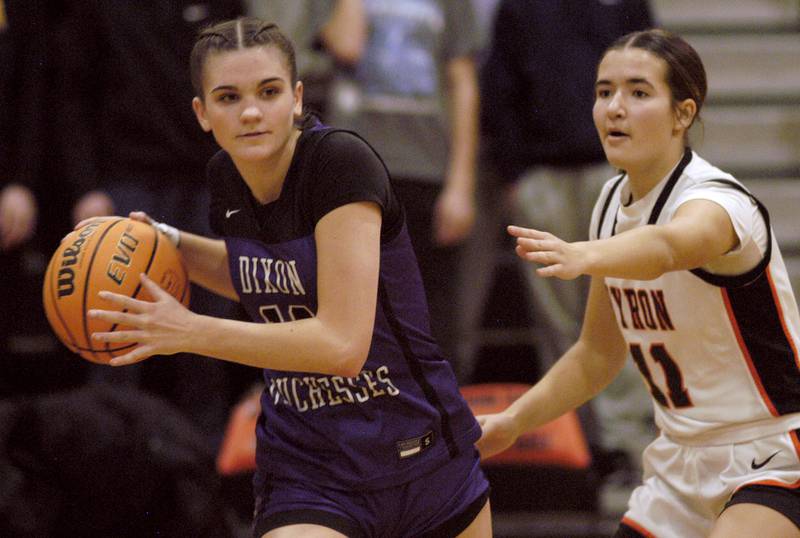 Dixon's Kiley Gaither passes the ball around  Byron's Alayna  Brandt. The Byron Tigers won over the Dixon Duchesses 46-43 in overtime. The girls basketball game took place at Byron on Saturday, January 24th, 2026