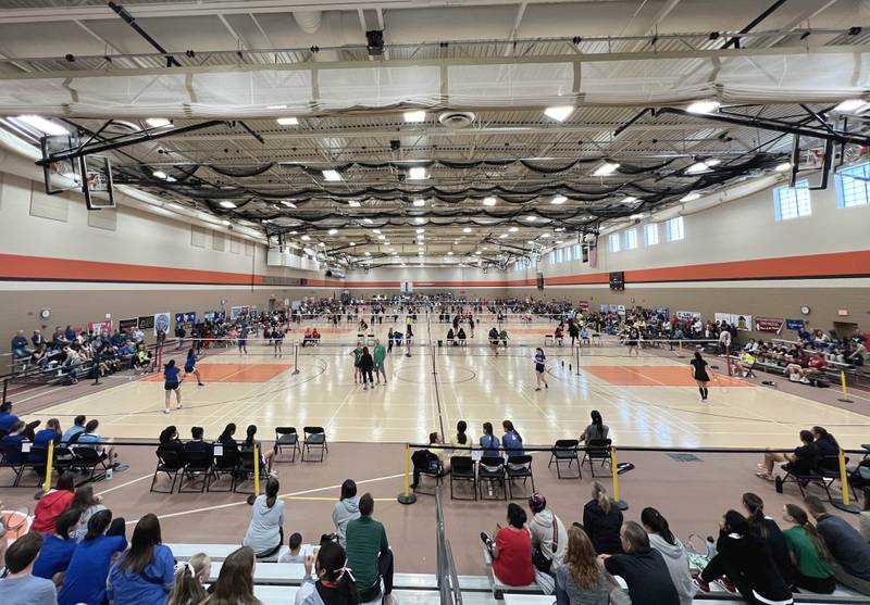 Several matches go on simultaneously on the 16 courts in the field house at DeKalb High School Friday, May 12, 2023, during the IHSA State Badminton Finals.