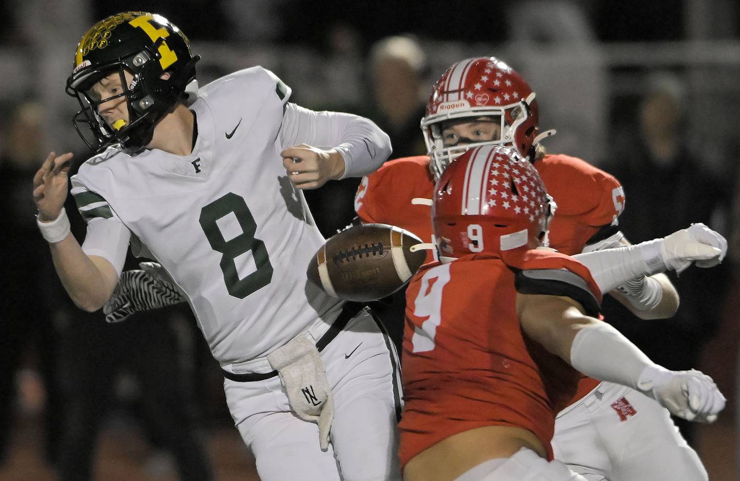 Naperville Central’s Jake Stanish strips the ball from Fremd quarterback Johnny O'Brien in a IHSA Class 8A second round playoff game in Naperville on Friday, Nov. 8, 2024. Stanish then recovered the ball.